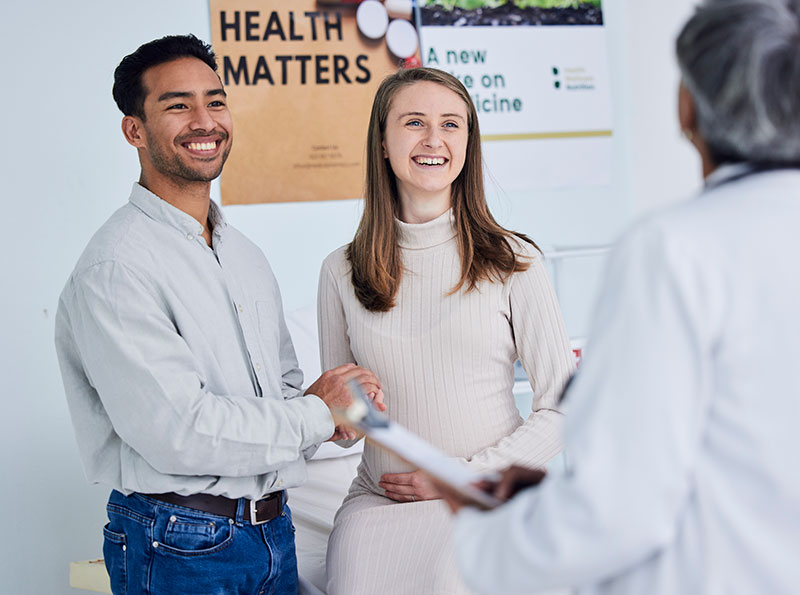 man and pregnant woman in doctors office using hsa