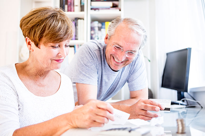 older couple at desk working on finances