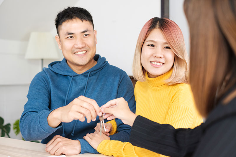 couple getting the keys to their new home real estate mortgage loans helena mt